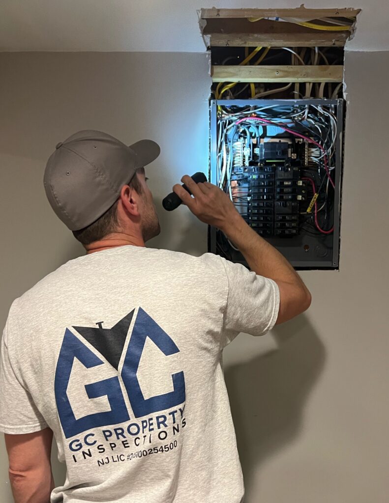 Greg from GC Property Inspections LLC inspecting a residential main electrical panel